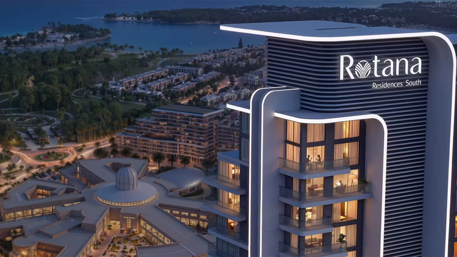 Aerial view of Rotana Residences Al Reem Island Abu Dhabi showcasing branded waterfront tower and city skyline at dusk